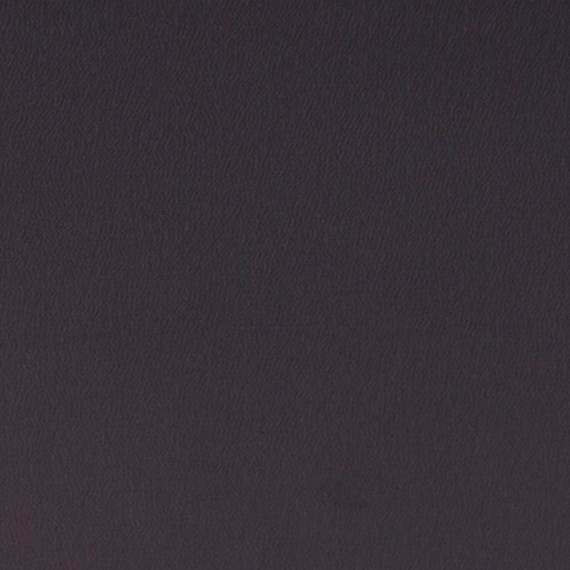 Deep charcoal-black woven fabric showing a fine, subtly rippled surface texture