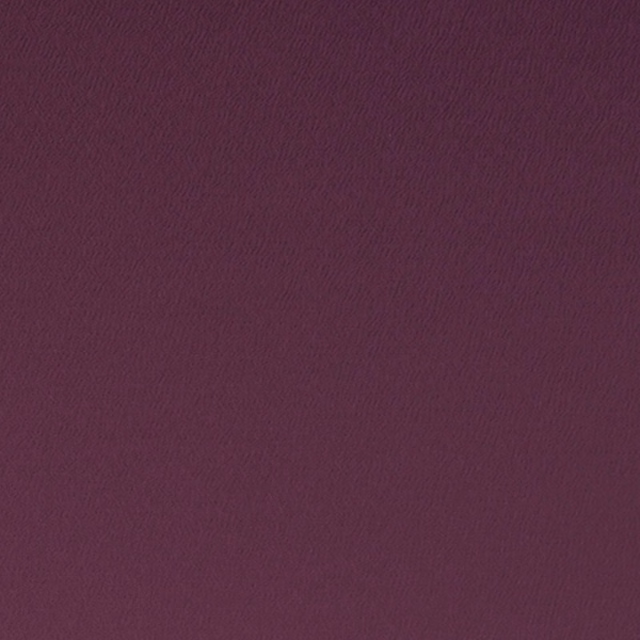 Deep grape-purple woven textile with a subtle rippled, light-catching surface
