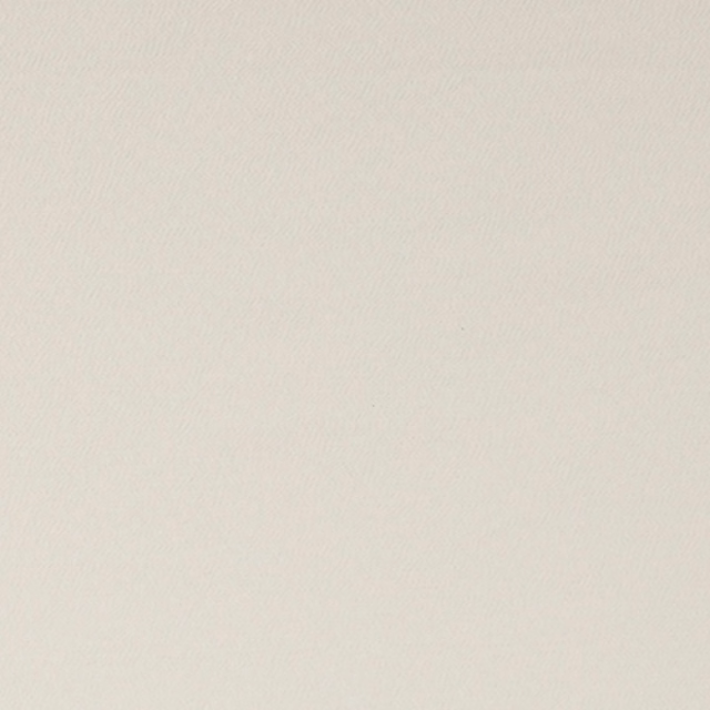 Close-up of softly textured warm ivory fabric with an almost plain woven surface