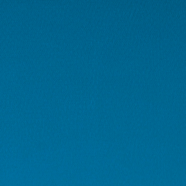 Close-up of saturated peacock teal cloth with a fine, softly rippled weave