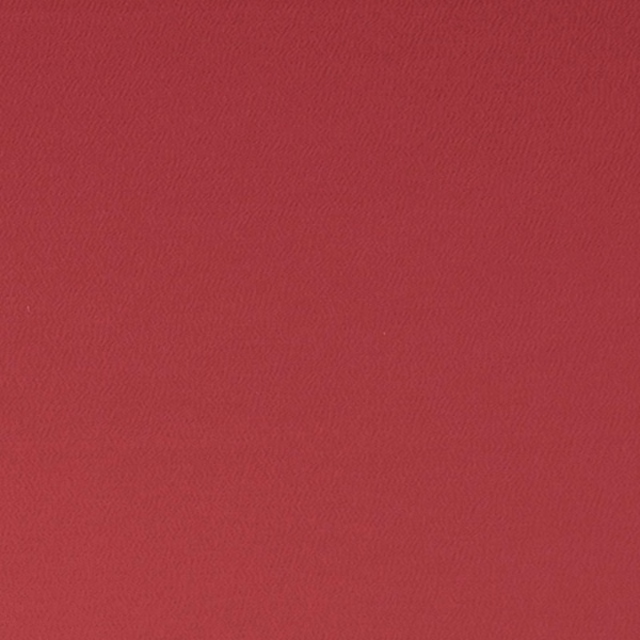 Close-up of deep ruby red fabric with a fine, softly rippled weave