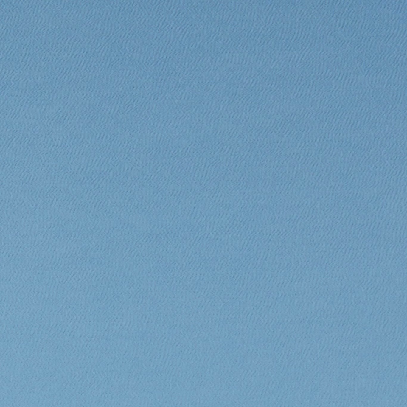 Close-up of cool sky-blue fabric with a fine, subtly rippled woven texture
