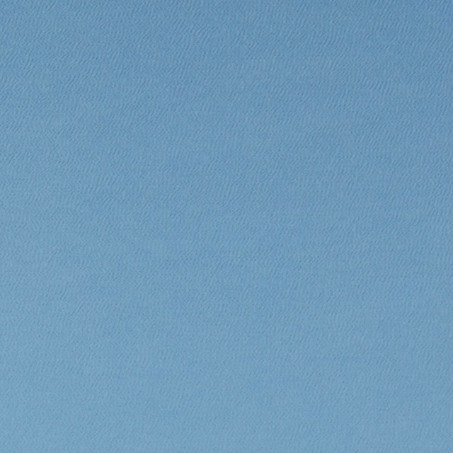 Close-up of cool sky-blue fabric with a fine, subtly rippled woven texture