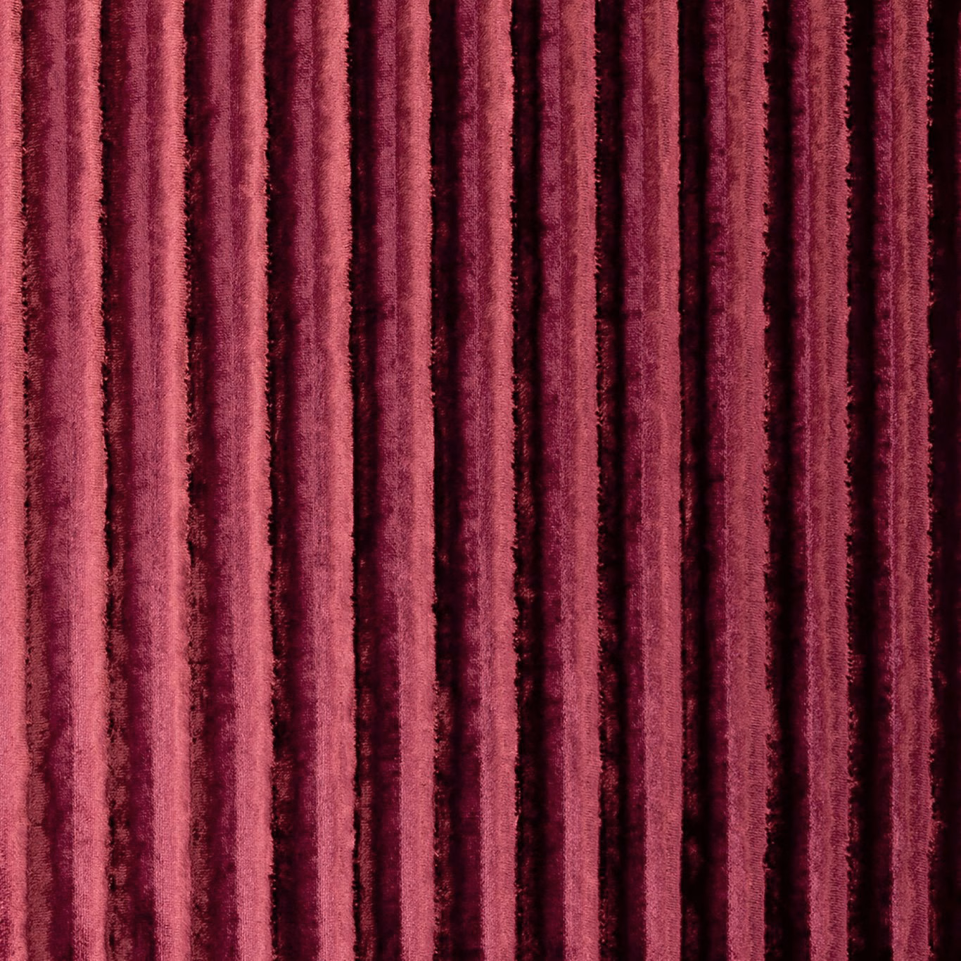Plush raspberry velvet with irregular vertical wine-toned striations and light-catching pile