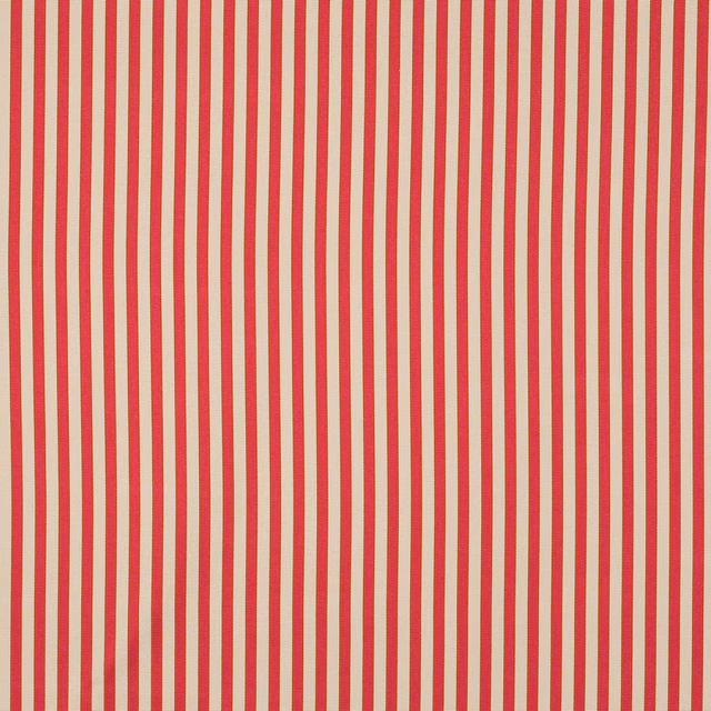 Vertical coral pink and cream striped fabric with a smooth woven texture