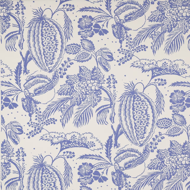 Blue botanical cotton fabric with large printed floral and fruit motifs on a pale ground