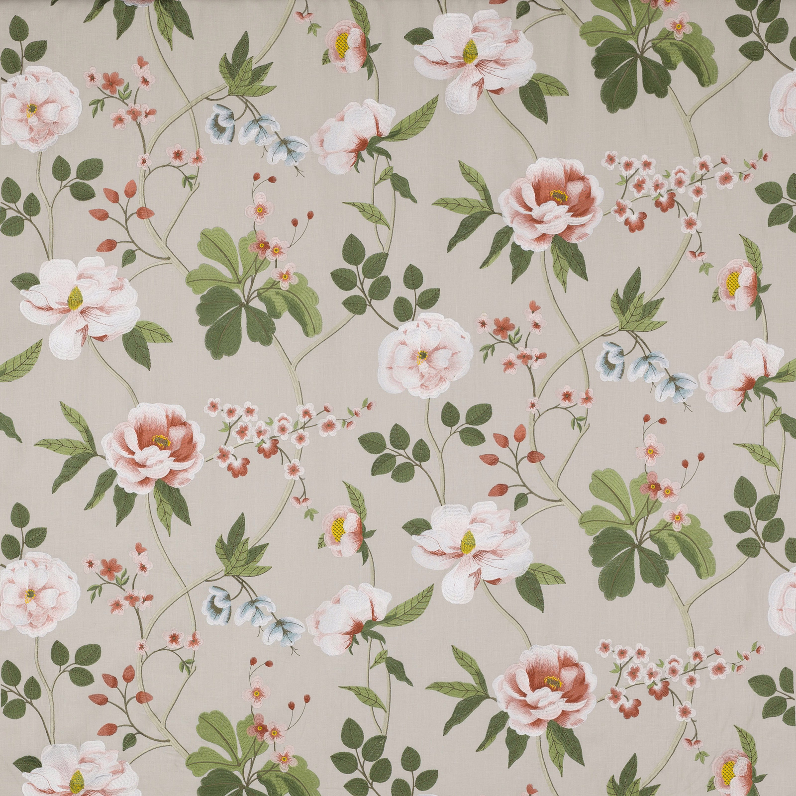 Cream floral fabric with coral blossoms and green trailing leaves