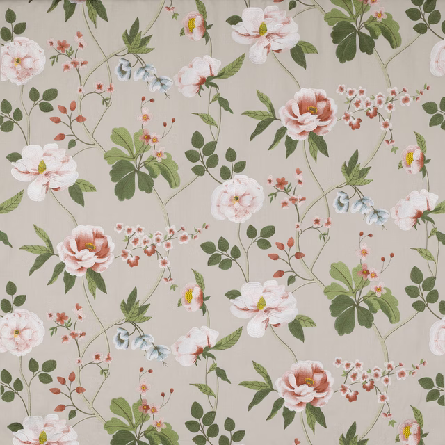 Cream floral fabric with coral blossoms and green trailing leaves