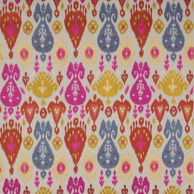 Cream woven fabric with large ikat-style motifs in coral, blue, magenta and gold