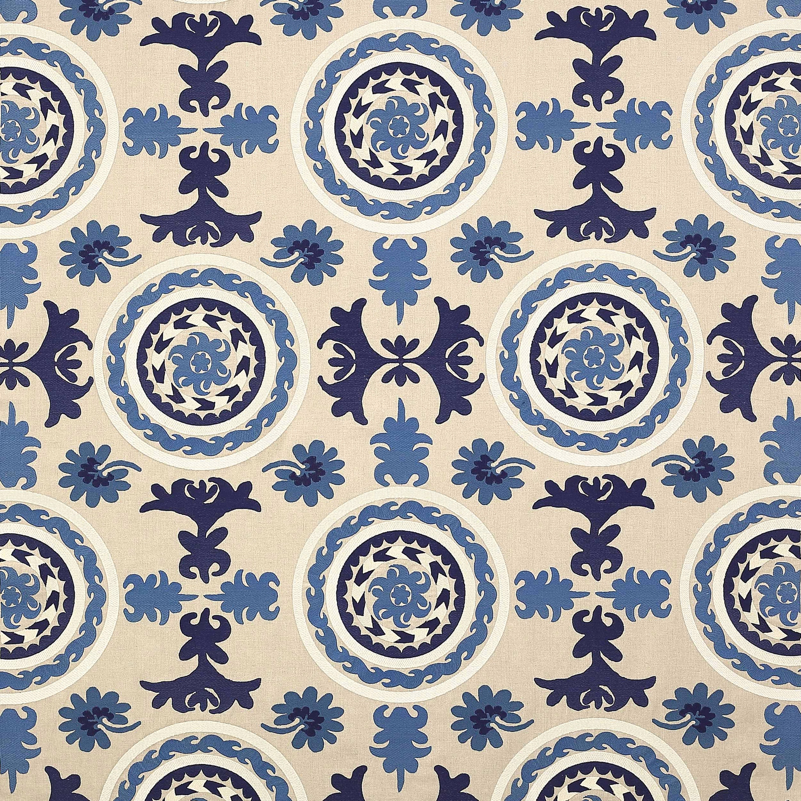 Blue and navy circular damask fabric on a warm ivory ground