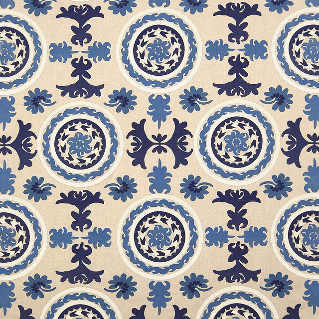 Blue and navy circular damask fabric on a warm ivory ground