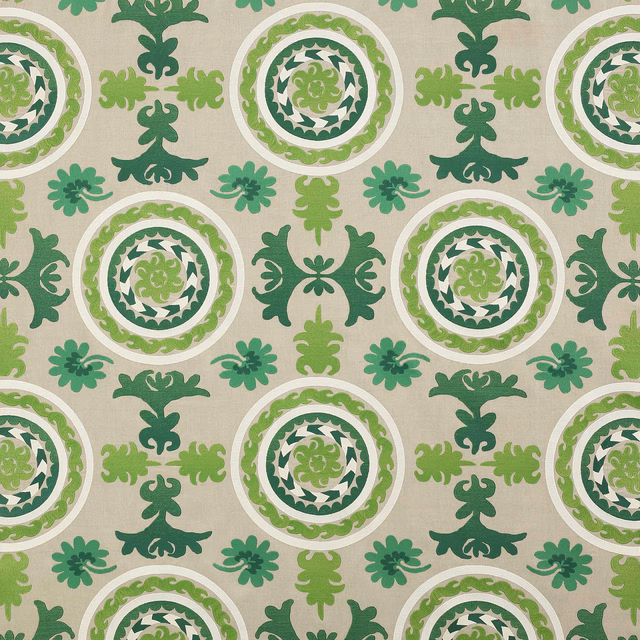 Green geometric fabric with circular medallions and scroll motifs on a neutral ground