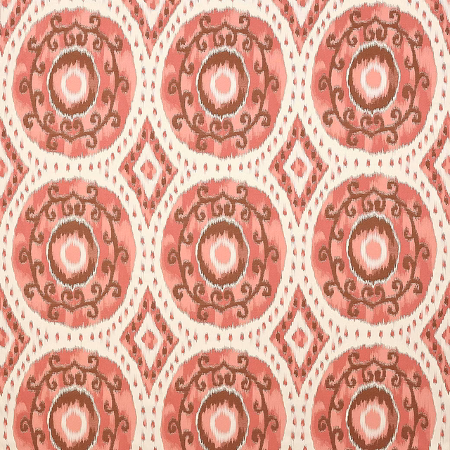 Warm pink patterned fabric with circular medallions and brown scroll detailing