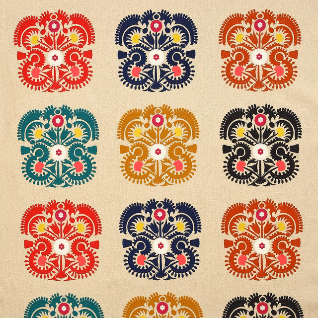 Cream ground fabric with repeating terracotta, navy, teal and black damask medallions