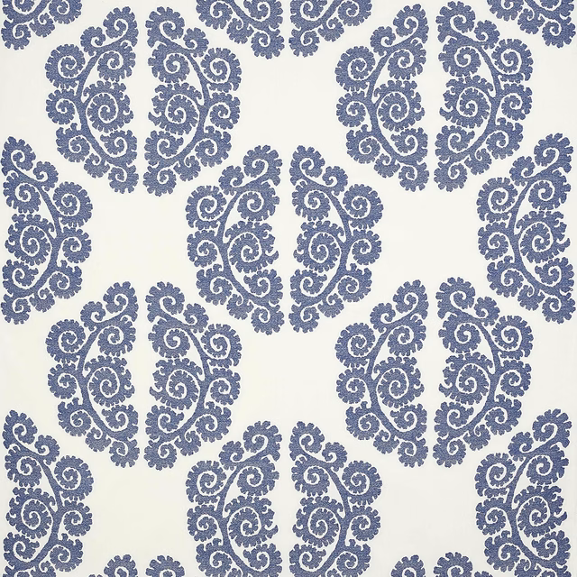 Blue scrolling damask motif on a pale cream woven fabric swatch