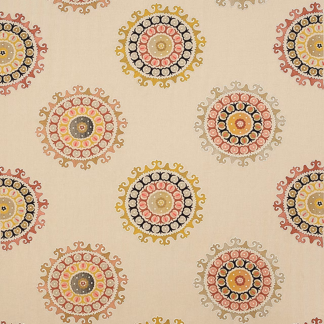 Cream fabric swatch with circular coral, gold and black medallion motifs