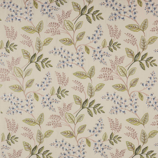 Cream botanical fabric with blue flower sprigs and sage-green leaves