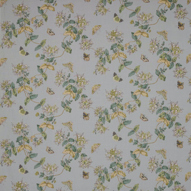Powder blue linen fabric with trailing florals and butterflies in soft green and yellow