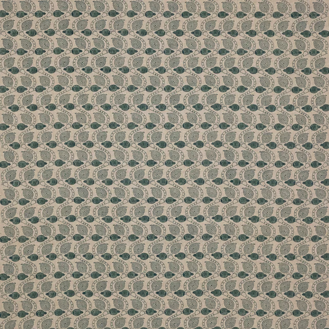 Small repeating green leaf-and-dot block print on flax linen