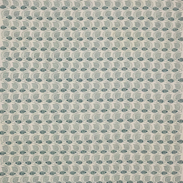 Pale linen fabric with small repeated blue block-print leaf and berry motifs
