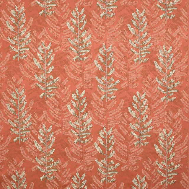 Coral-red botanical fabric with pale leaf motifs and textured woven surface