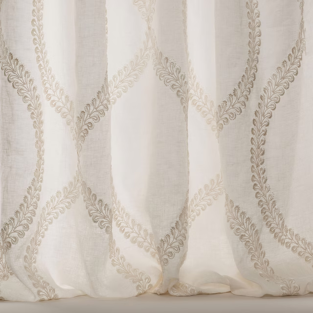 Ivory sheer fabric with large scrolling embroidered motif and soft linen texture