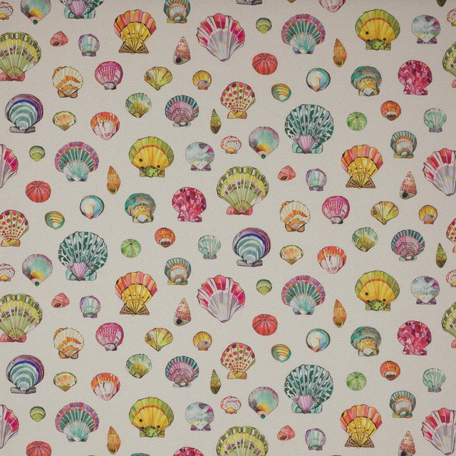 Cream fabric swatch with scattered multicoloured shell motifs and fine texture