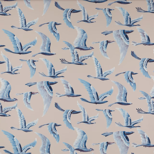 Large bird motif fabric with pale blue and white birds on a soft beige ground