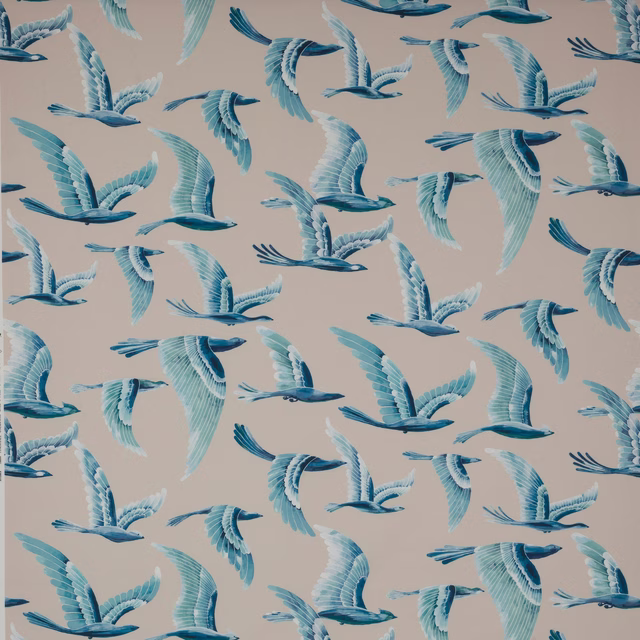 Blue and turquoise flying bird motif on a pale neutral fabric ground