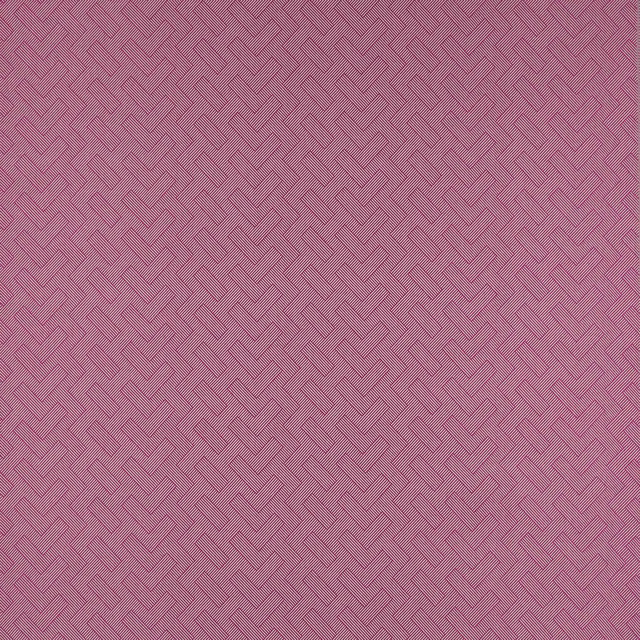 Close-up of a dusty pink geometric woven fabric with fine diagonal ribbing