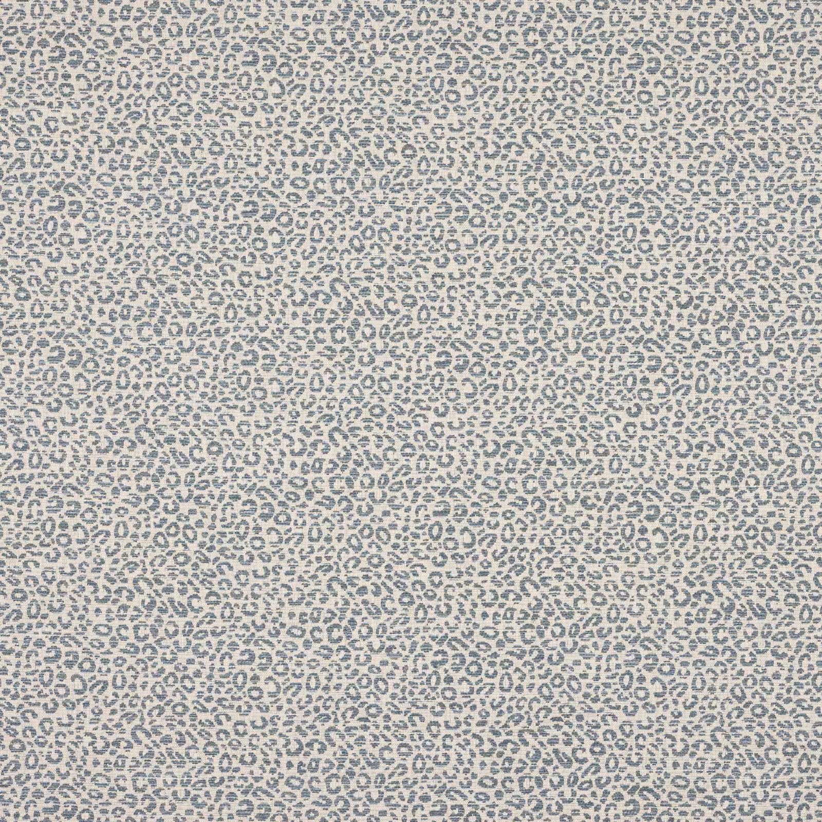 Close-up of small blue-grey animal spots on a pale textured woven fabric
