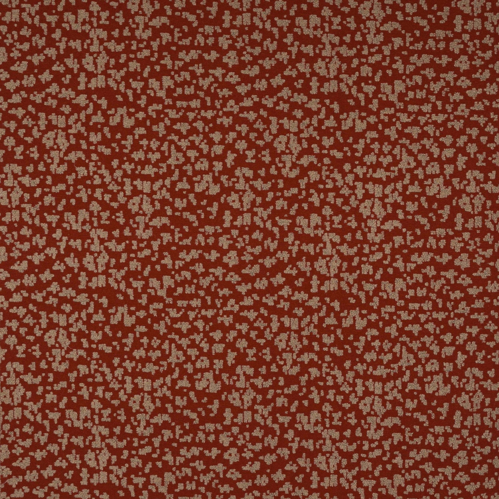 Rusty red woven fabric with small pale speckled abstract pattern