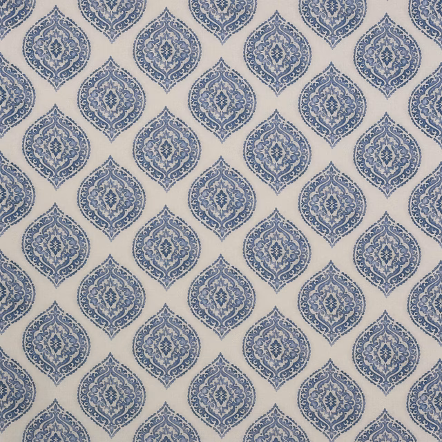 Ivory fabric swatch with repeating indigo damask medallions and fine woven texture