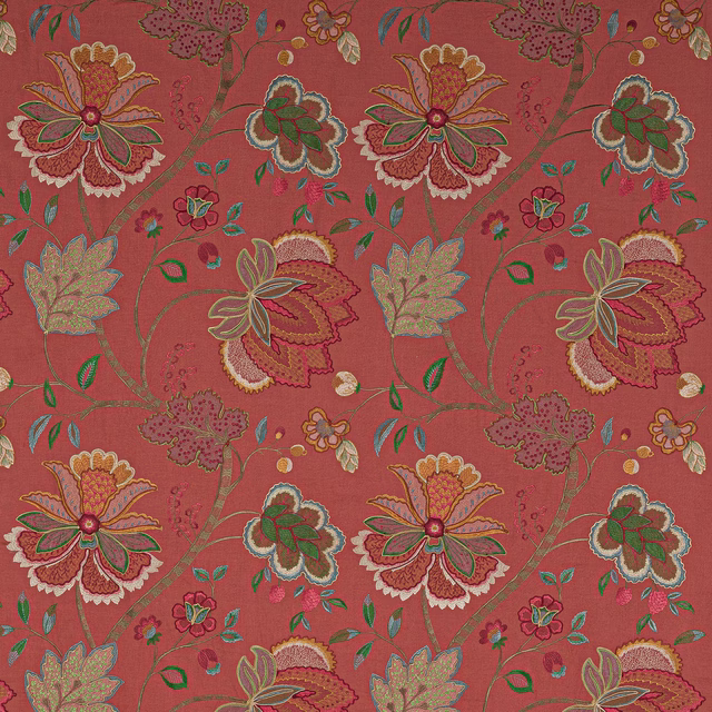 Coral red floral fabric with embroidered-style blossoms and curling stems