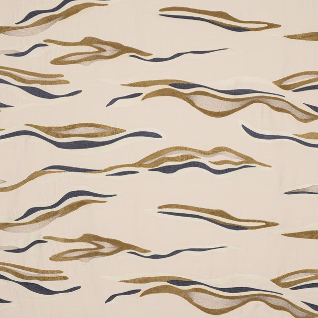 Cream fabric swatch with sweeping gold and navy abstract ribbon stripes