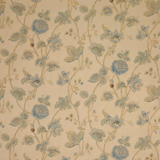 Cream-ground floral fabric with soft blue blossoms and trailing leafy stems