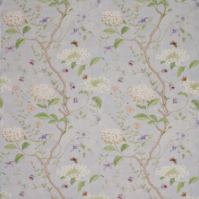 Pale blue linen fabric with trailing floral branches, butterflies and soft botanicals