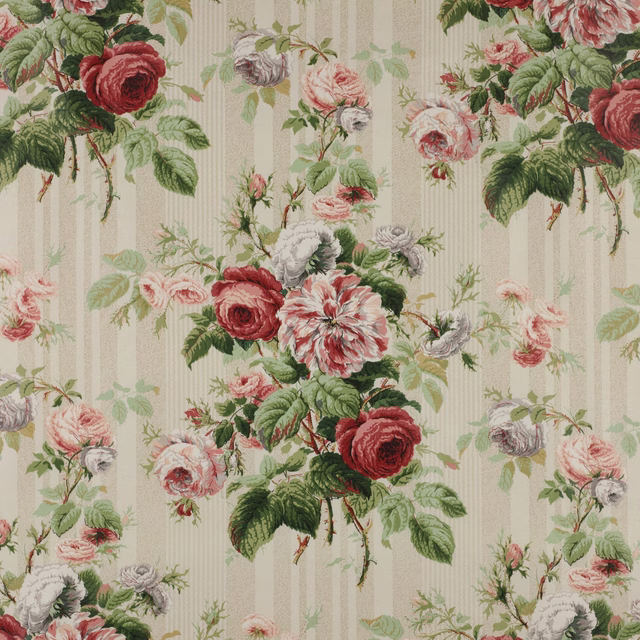 Large rose floral cotton print with red blooms, blush flowers and green foliage on a pale striped ground