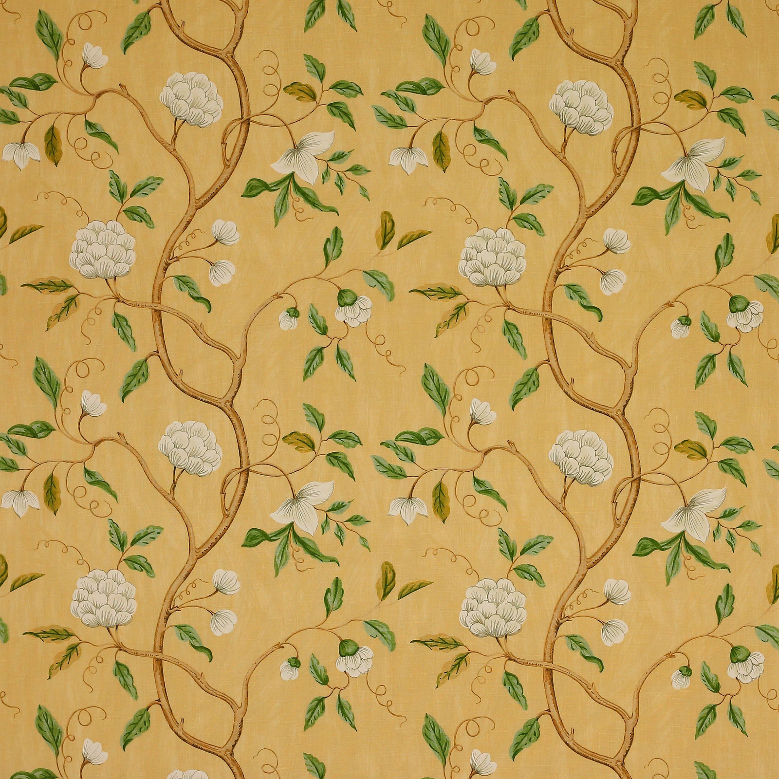 Gold linen fabric with scrolling branches, white blossoms and green leaves