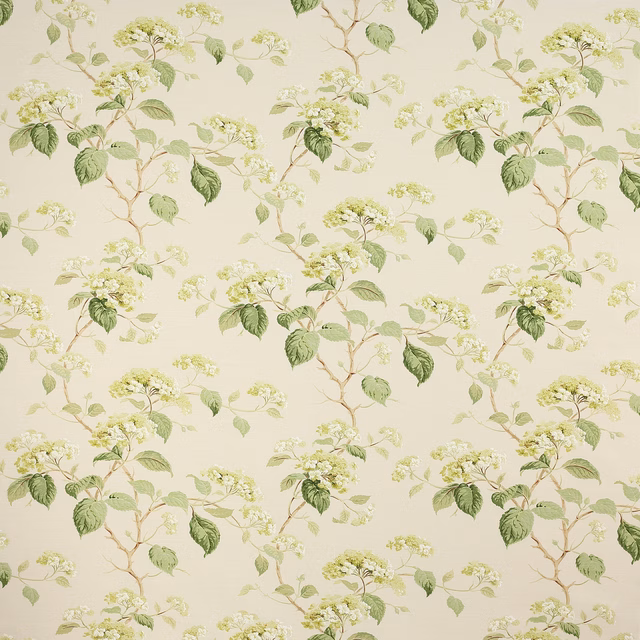 Large green leafy floral print on a cream ground, with airy blossom clusters
