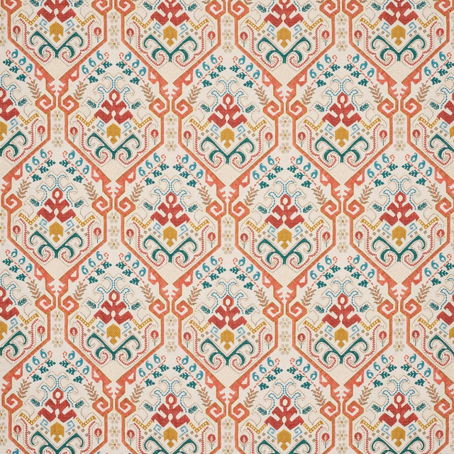 Terracotta red geometric fabric with teal, gold and cream pattern on a pale ground