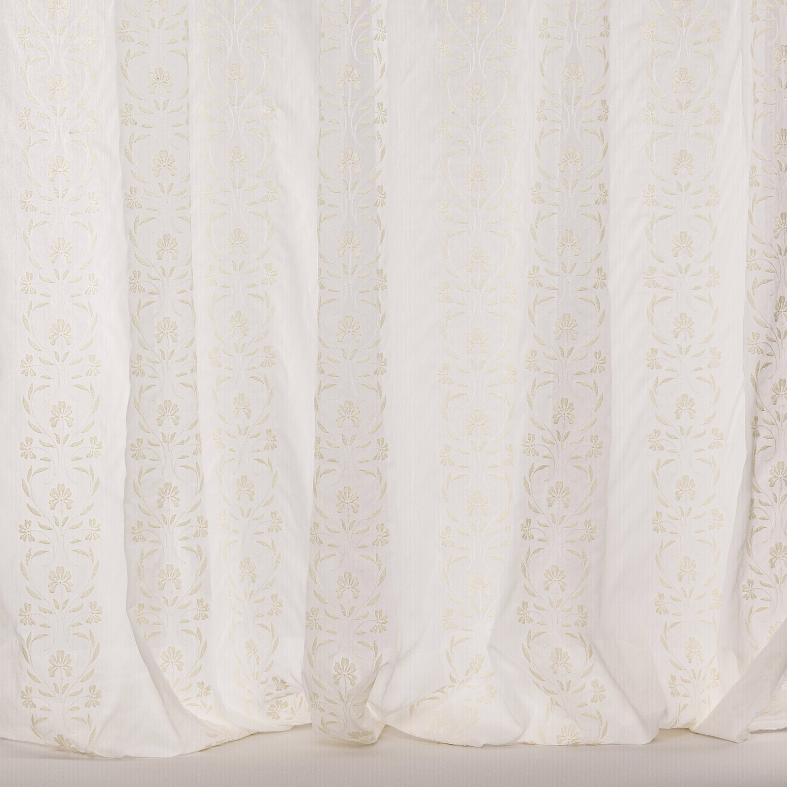 Ivory sheer curtain fabric with subtle vertical floral stripe motif and soft drape
