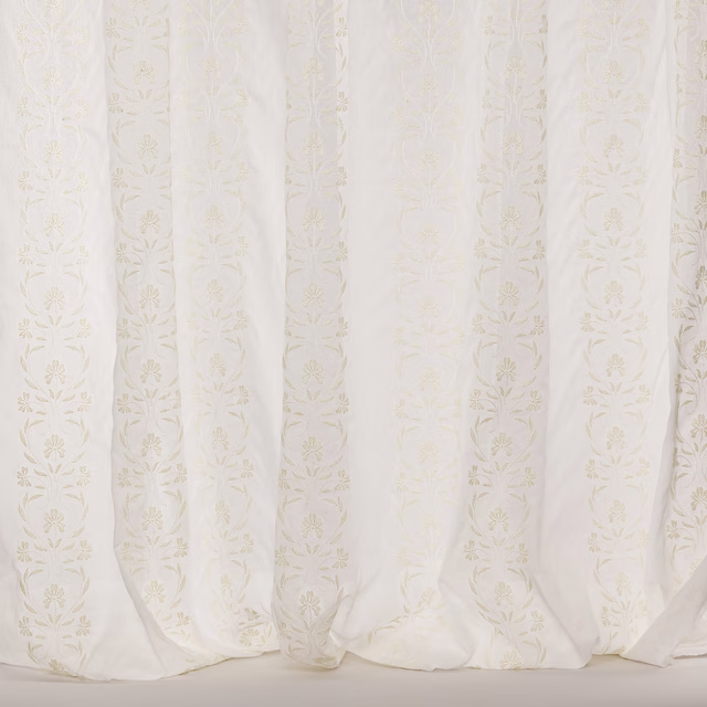 Ivory sheer curtain fabric with subtle vertical floral stripe motif and soft drape