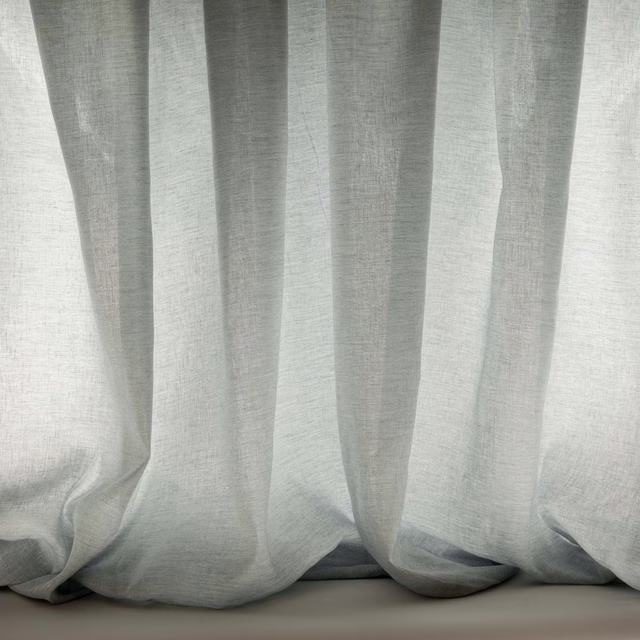 Pale misty blue sheer fabric hanging in soft vertical folds