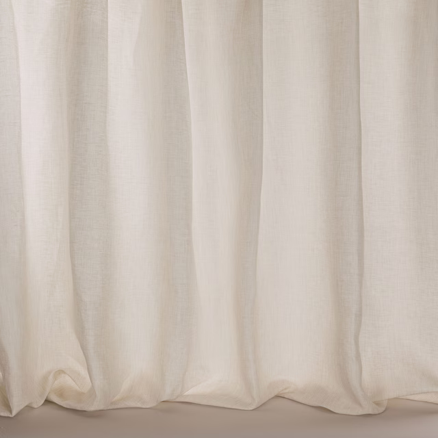 Pale warm taupe sheer fabric hanging in soft vertical folds