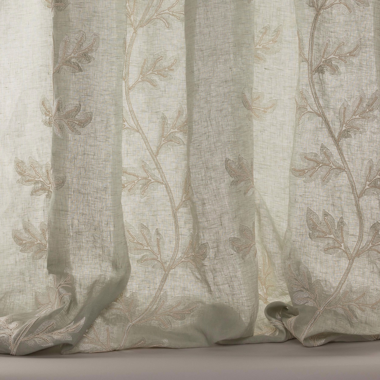 Pale old-blue sheer curtain fabric with trailing botanical leaf embroidery