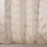 Sheer ivory embroidered curtain fabric with trailing leaf motif and soft silver tone