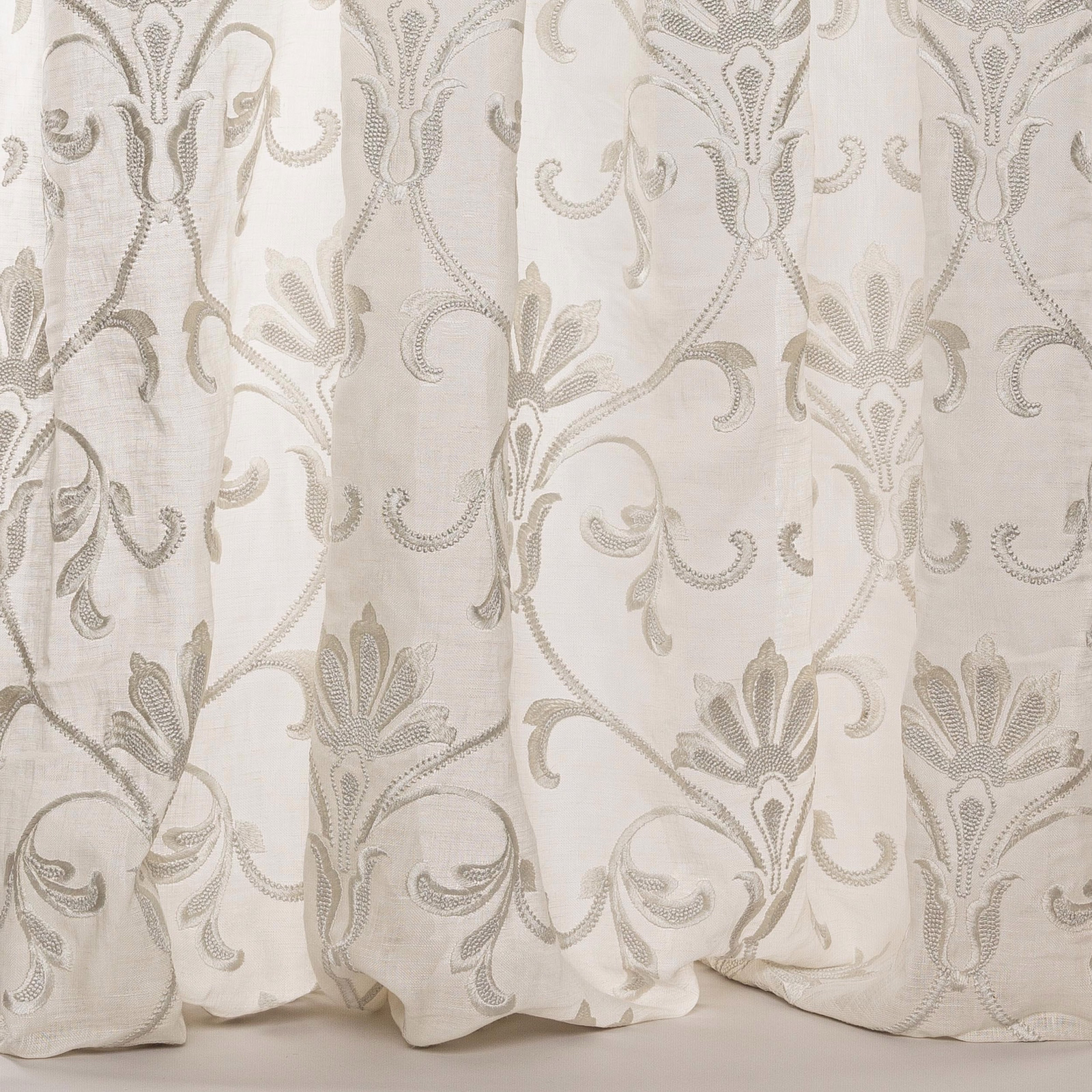 Pale silver-grey damask sheer with scrolling embroidered leaves and a linen texture