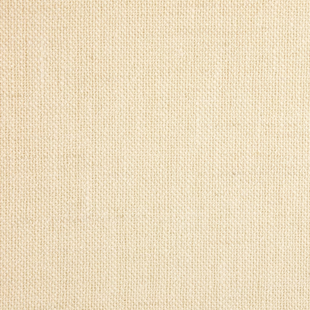 Close-up of warm pearl cream woven fabric with a fine, even texture