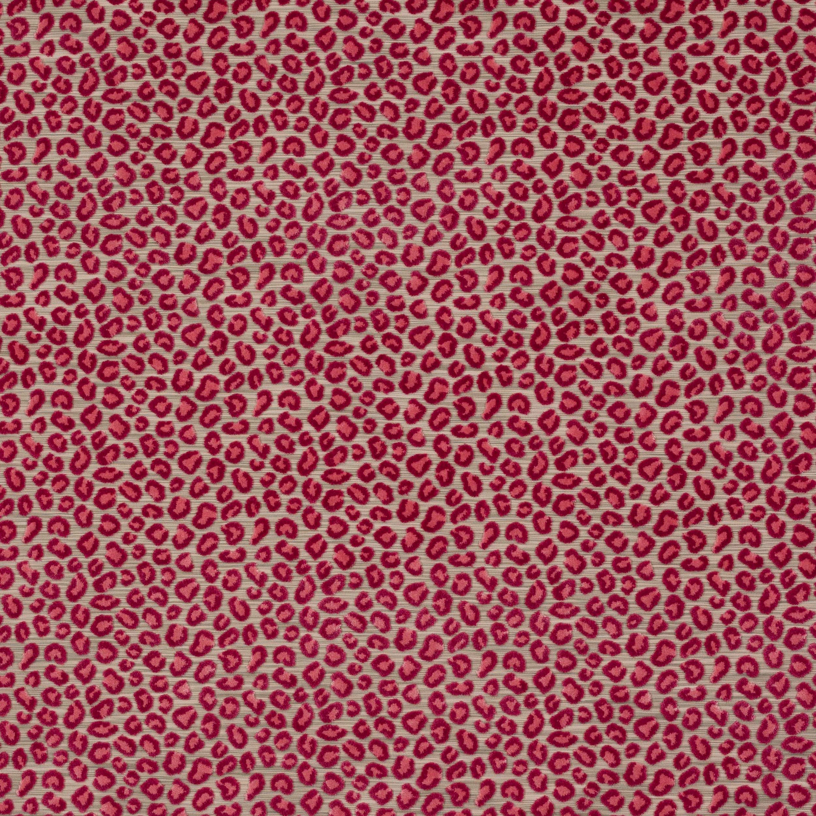Pink animal-print fabric with tiny raspberry spots on a soft warm ground